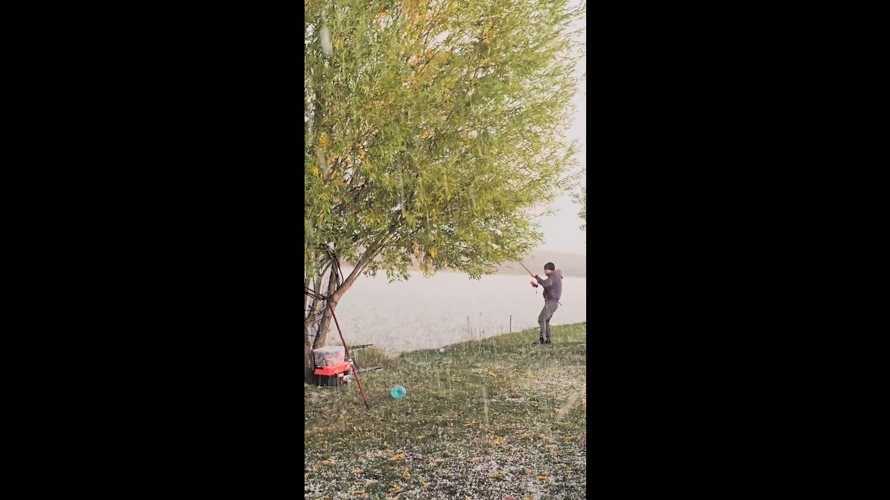 Man keeps fishing as graupel falls in Teleorman, Romania