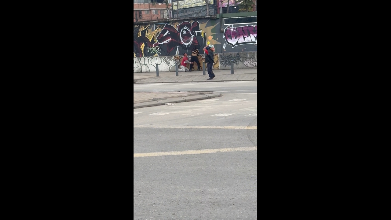 Man clings to woman’s legs in funny street scene in Bogotá, Colombia
