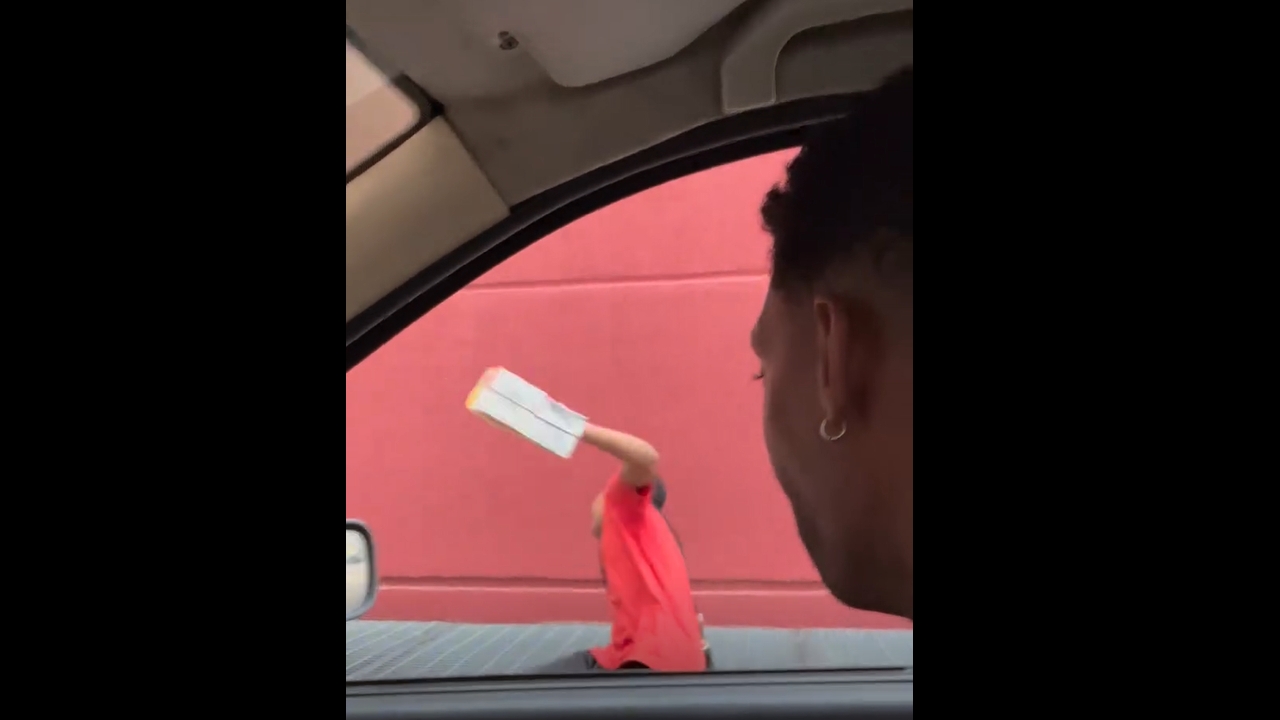 Child gets scared by passanger's funny face while walking in Itaboraí, Brazil