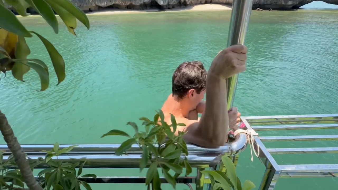 Man slips off boarding platform and falls into water on Cát Bà Island, Haiphong, Vietnam