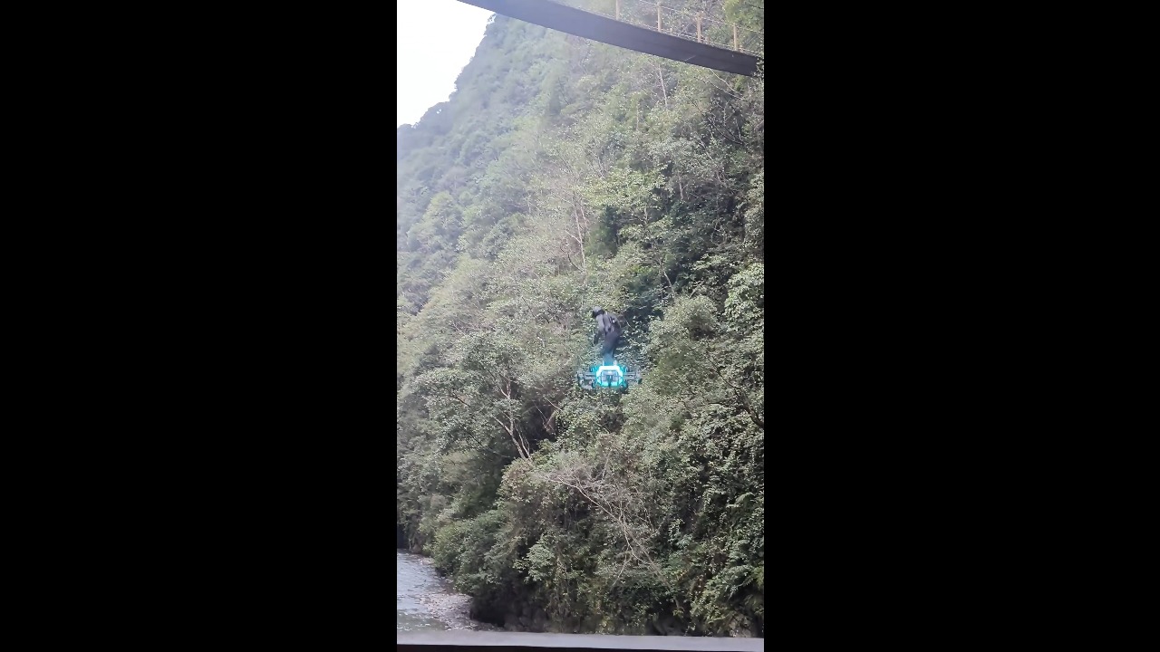 Man soars over canyon river on homemade electric hoverboard in Hubei, China