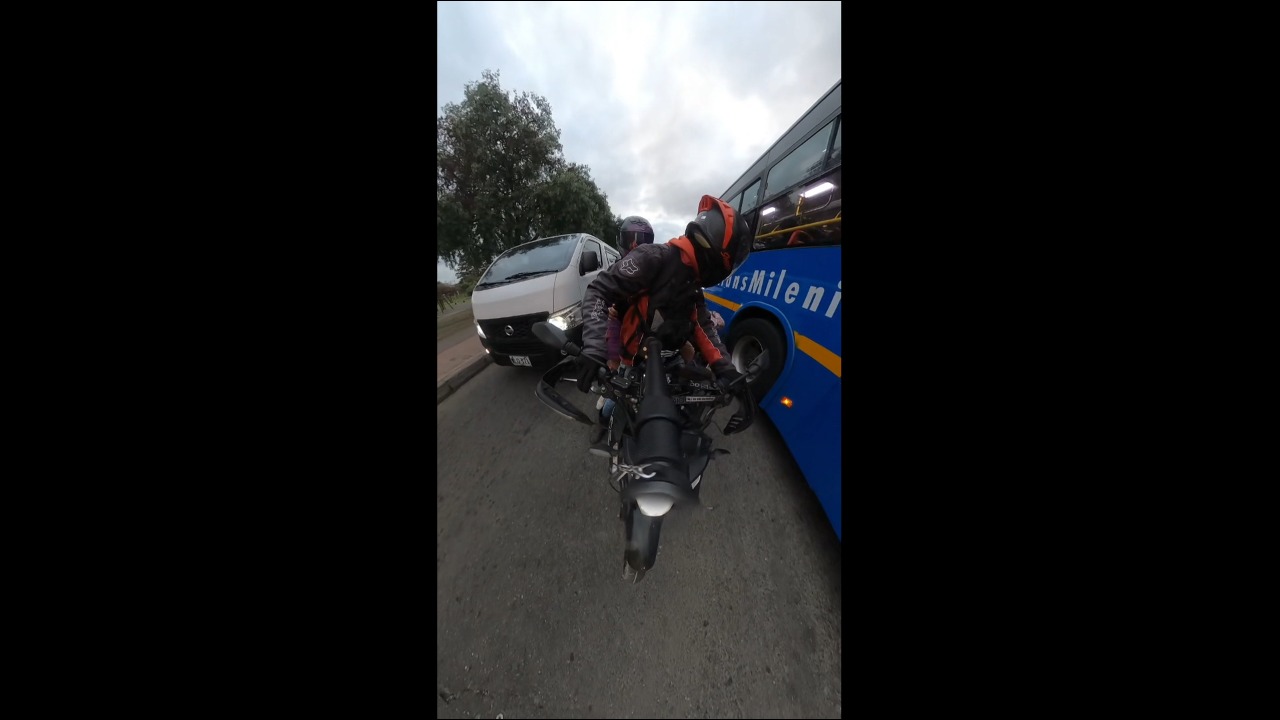Cyclist falls after colliding with a motorcycle amid traffic in Bogotá, Colombia
