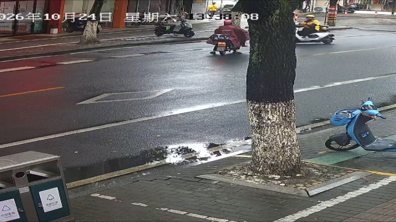 Two motorcyclists collide on wet road after one rider loses control in Zhejiang, China