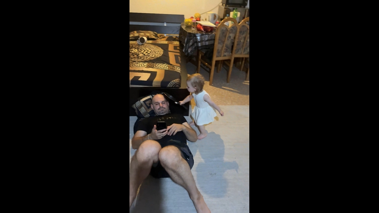 Toddler playfully taps her father with a frying pan in Böblingen, Germany