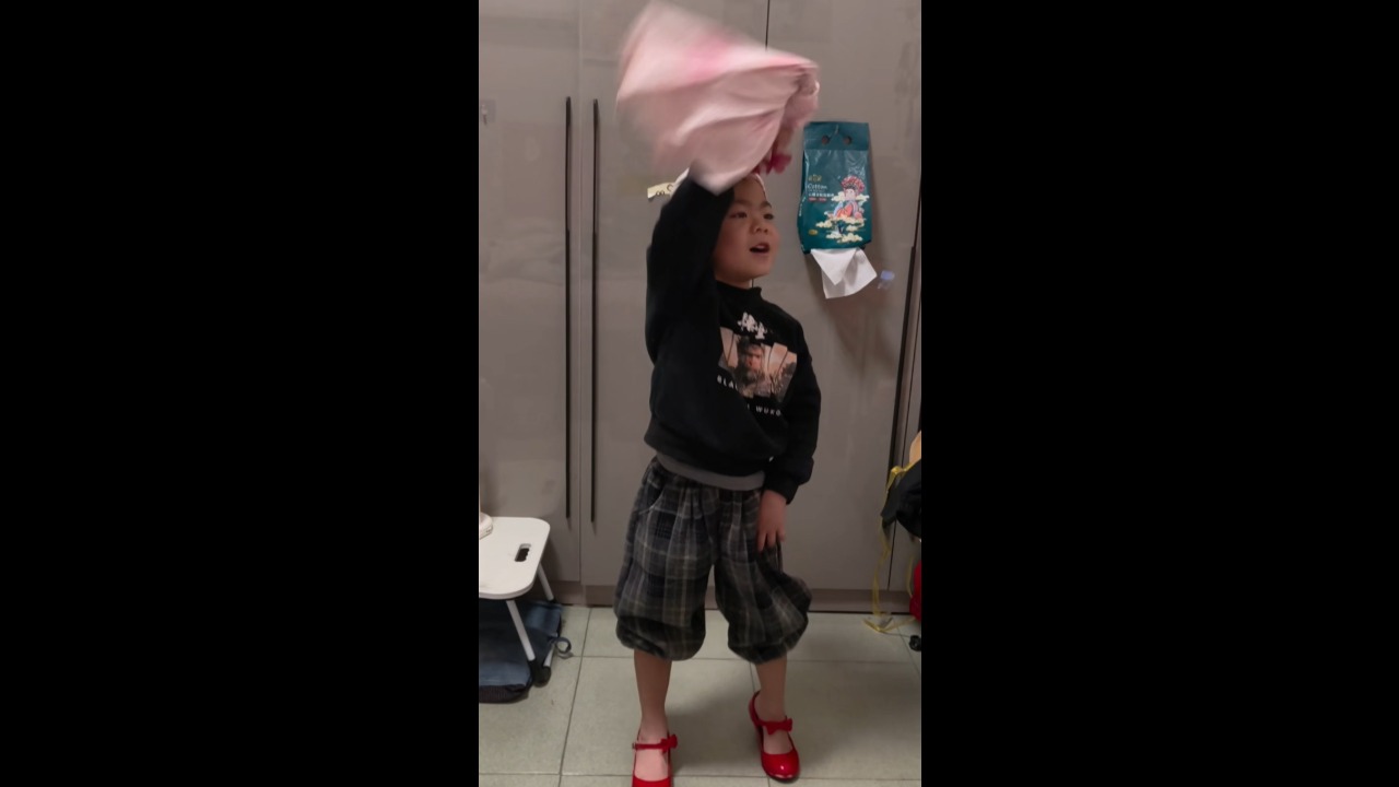 Boy hilariously struts in high heels and performs a catwalk at home in Shanxi, China