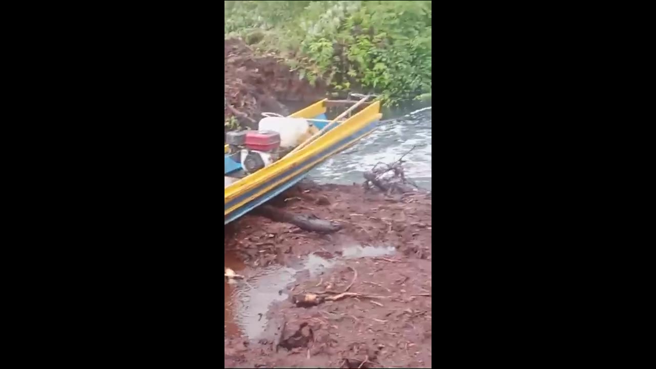 Adventurous canoe flight: fishing enthusiast soars over divided river in Palembang, Indonesia