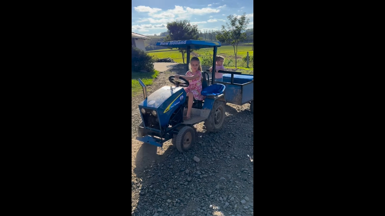 Young girl skillfully drives tractor in Taió, Brazil