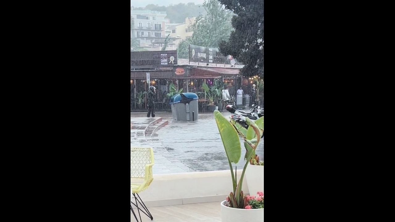 Trash bin swept away by flood waters during rainstorm in Santa Ponça, Spain