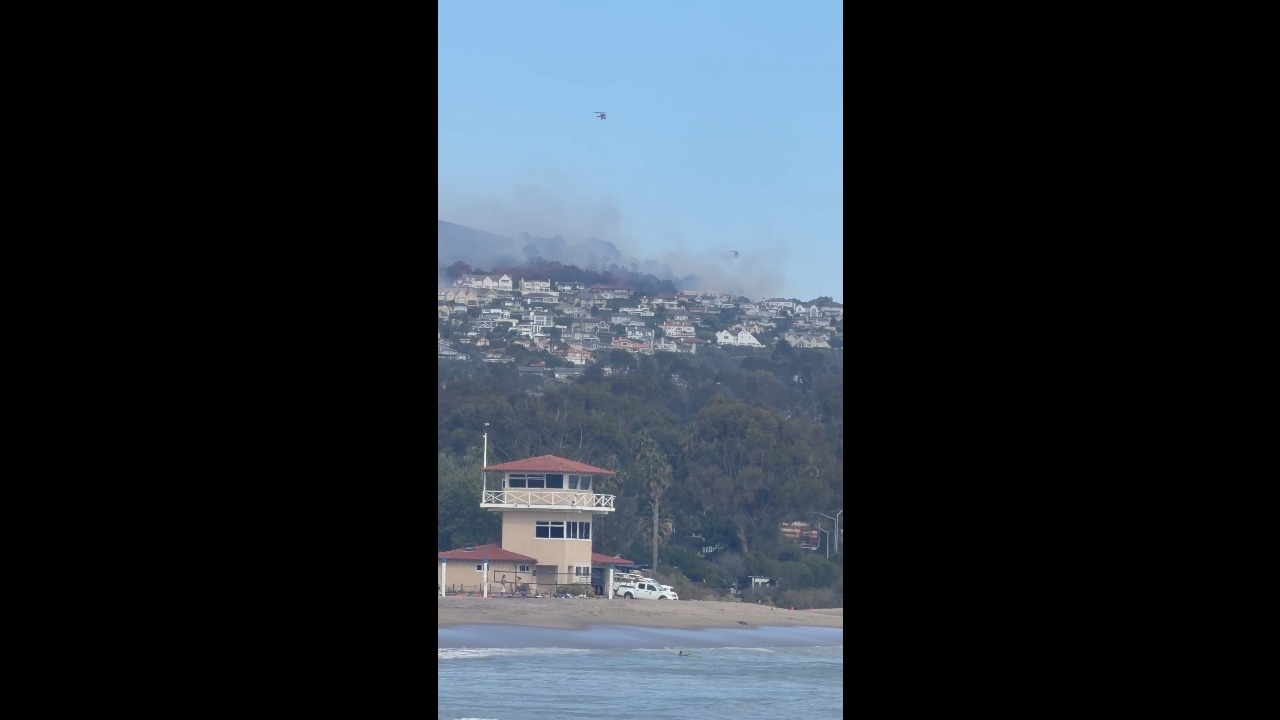 CH-47 Chinook helicopter battles Norte Fire as smoke rises along the California coast, USA