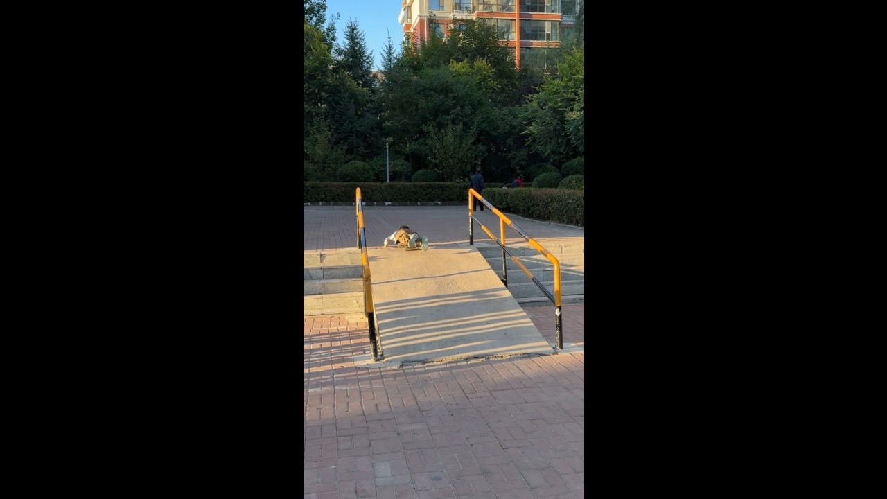 Boy loses control of skateboard and crashes on a park ramp in Jilin, China