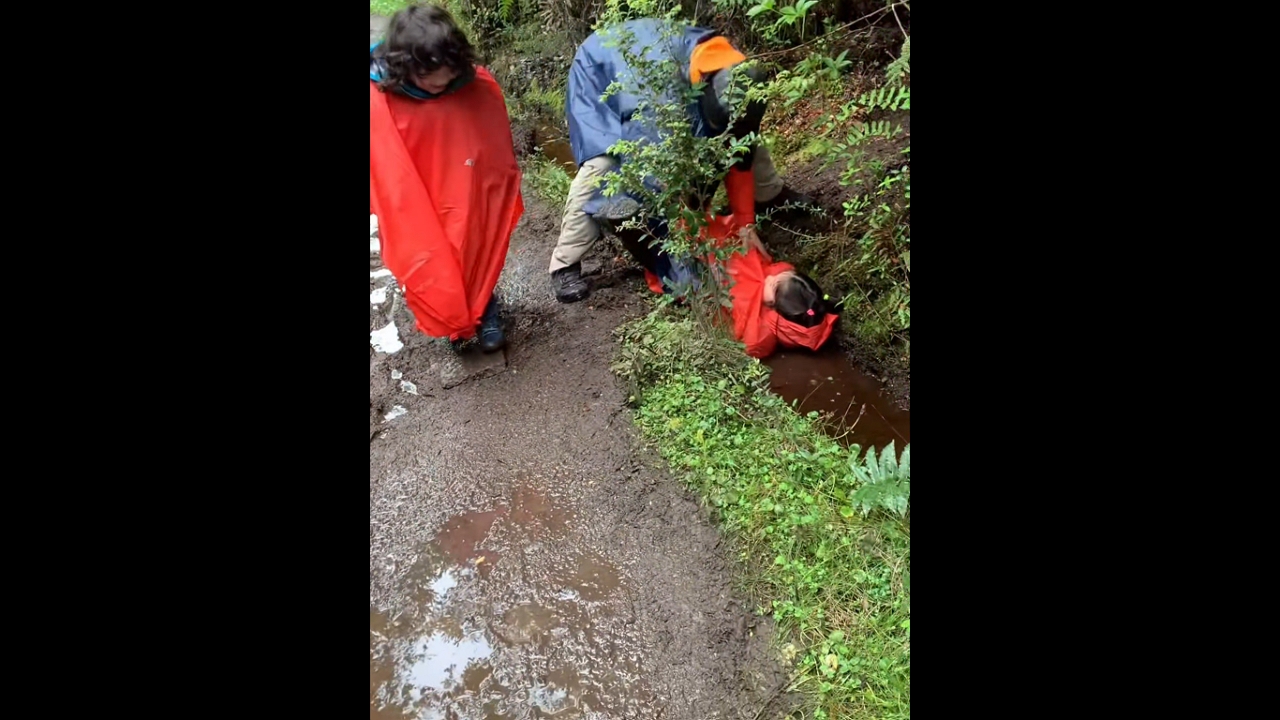 Little girl falls into mud in at a national park in Chiloé, Chile