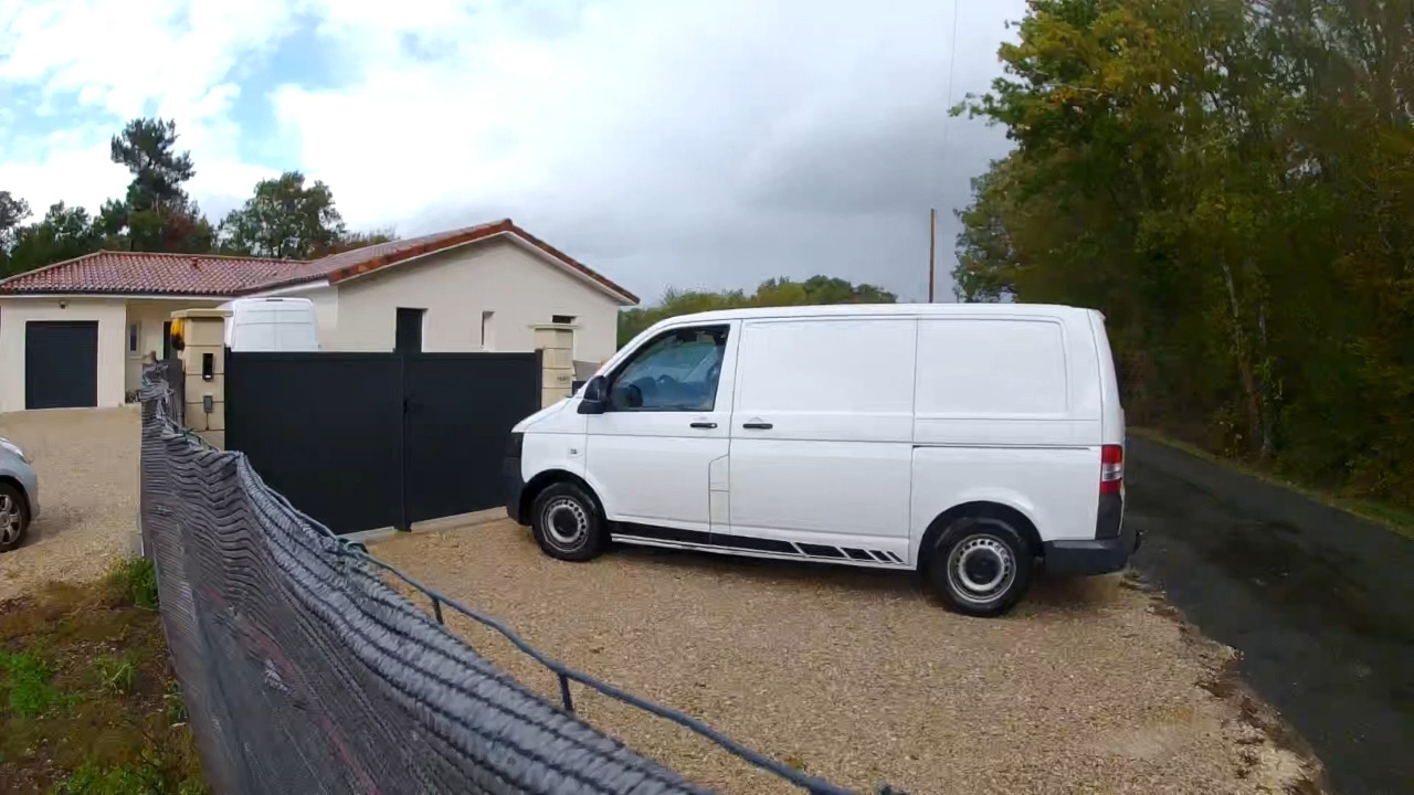 Driver skillfully drifts Volkswagen T5 van along a wet country road in Creyssensac-et-Pissot, France