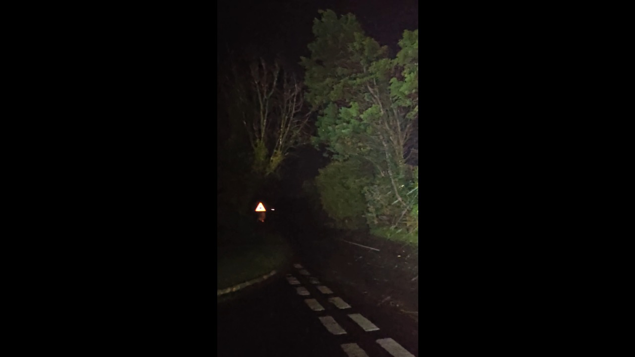 Storm Austen unleashes heavy rain and fierce winds along a rural road in Cornwall, UK