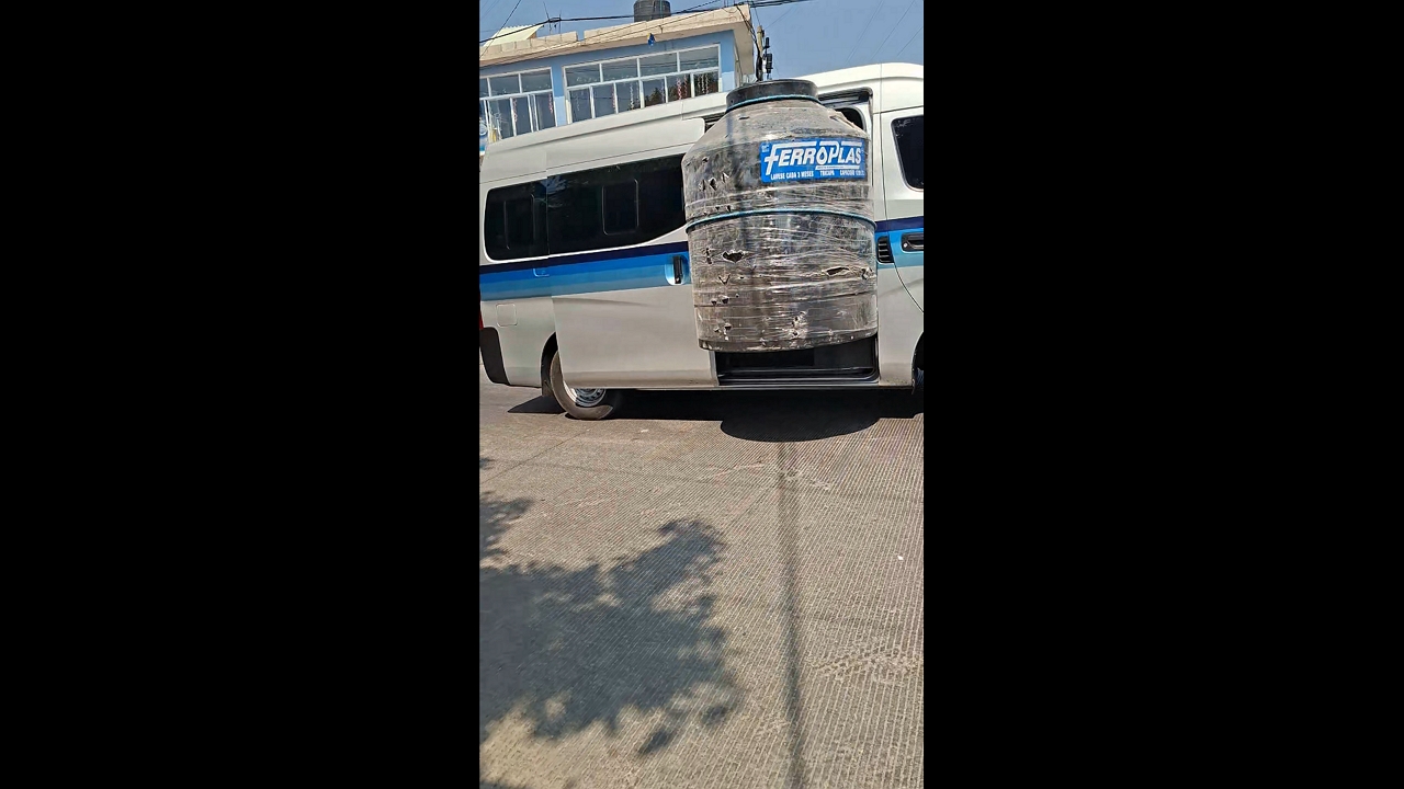 Van transports oversized tank sticking out of vehicle in Tetela del Volcán, Mexico