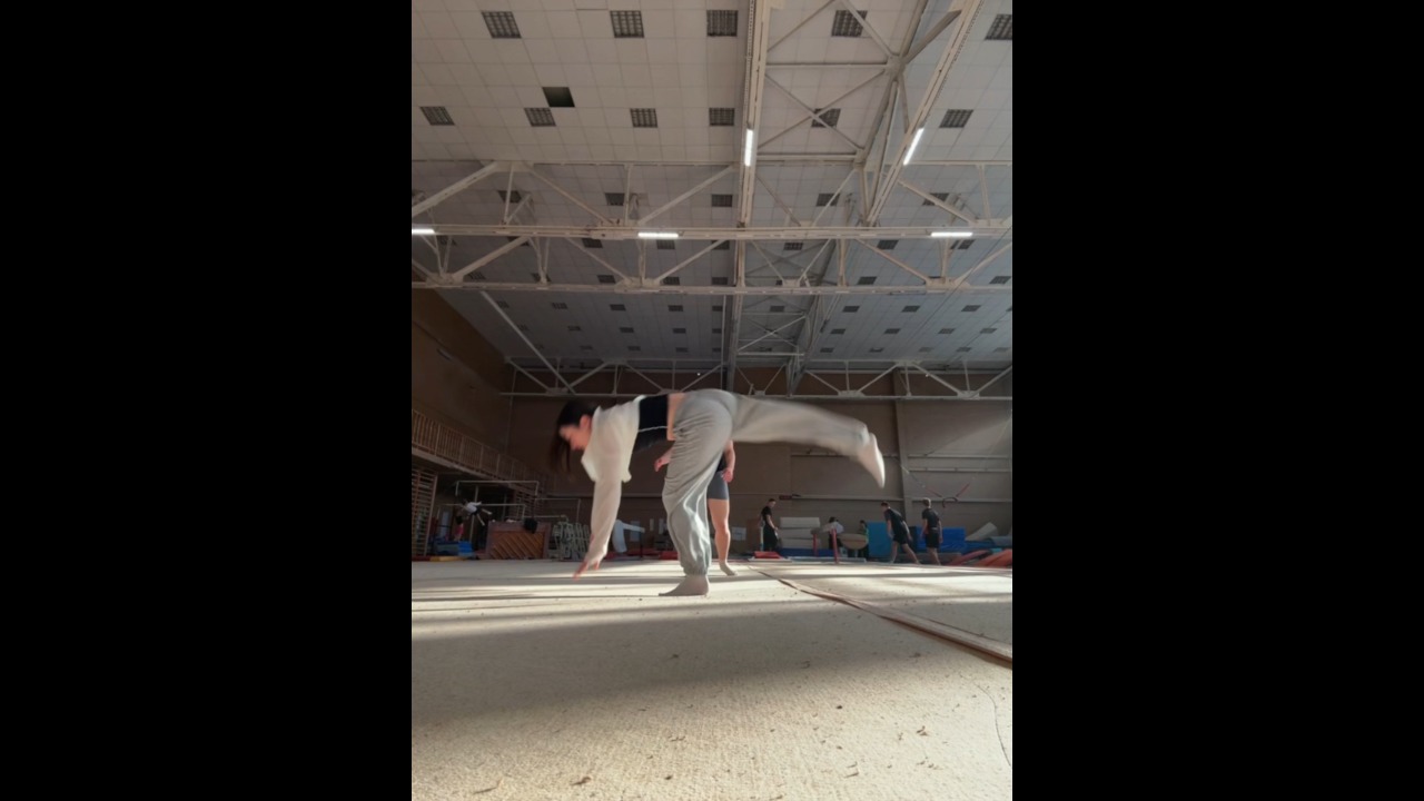 Woman loses her balance and falls during flip practice at a gym in Moscow, Russia