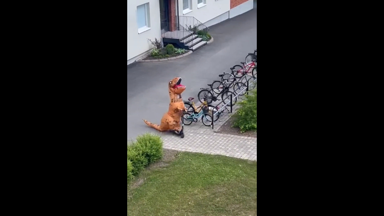 12-year-old rides scooter in dinosaur costume in Skövde, Sweden