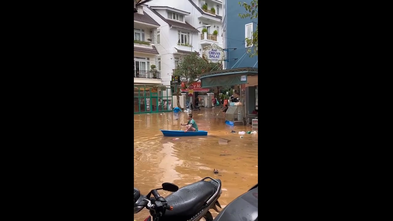 Man navigates flooded streets in Dalat City, Vietnam