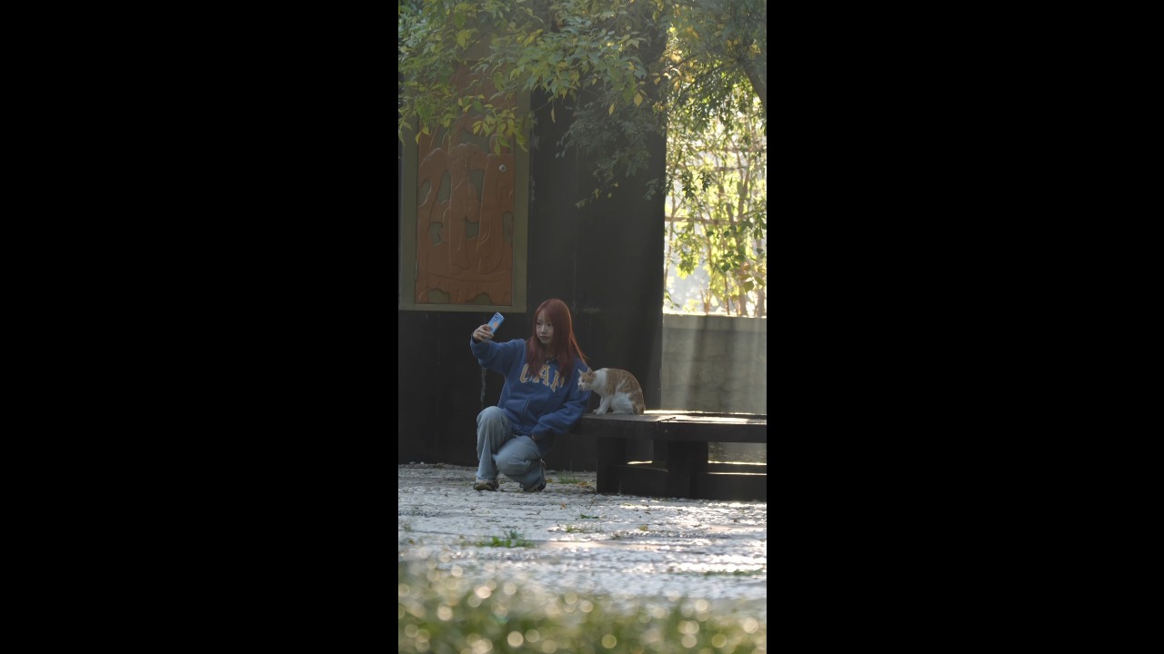 Woman takes an adorable selfie with a cooperative kitten during a morning walk in Shandong, China
