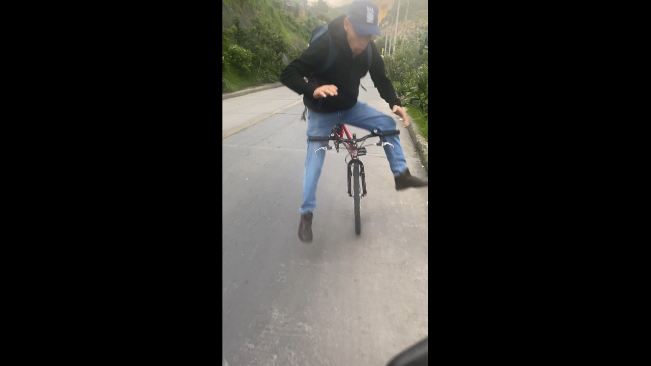 Near collision between motorcycle and biker in Bogotá, Colombia