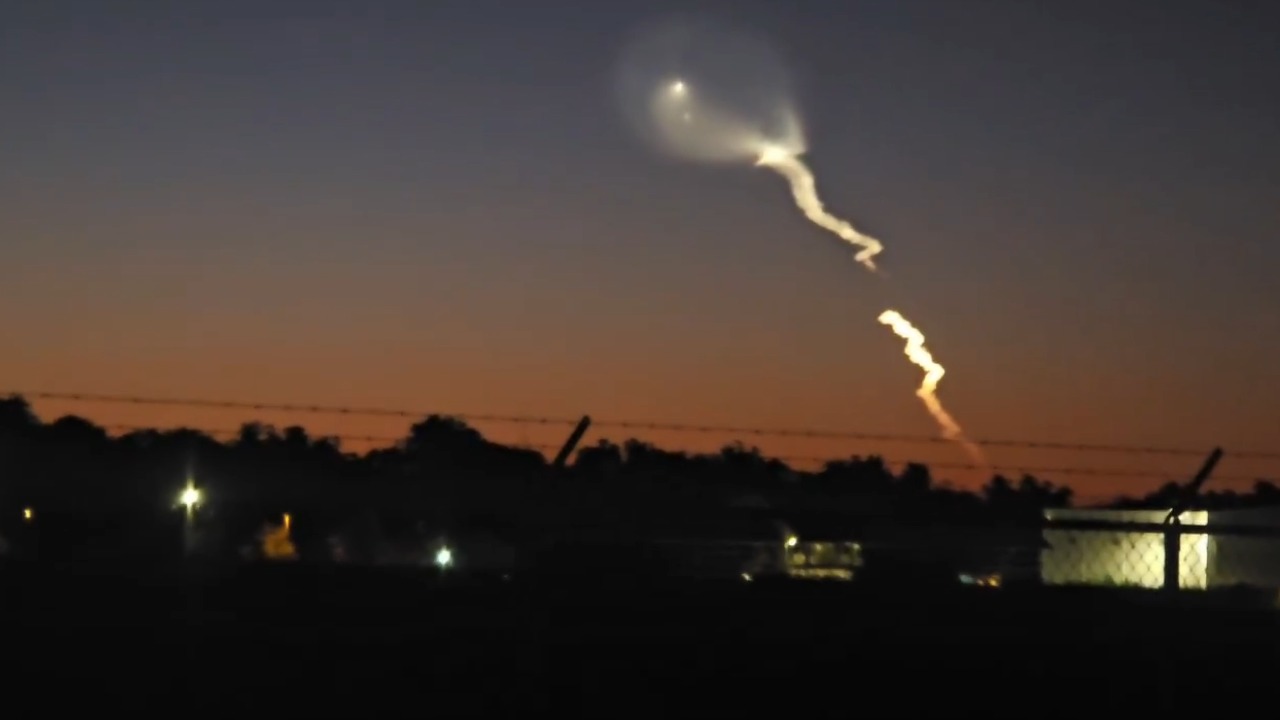 SpaceX rocket launch creates a glowing plume across the evening sky in Opelika, USA