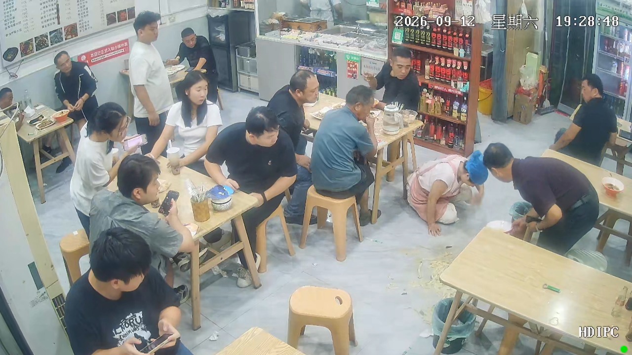 Restaurant worker slips and spills a bowl of noodle soup while serving customers in Anhui, China
