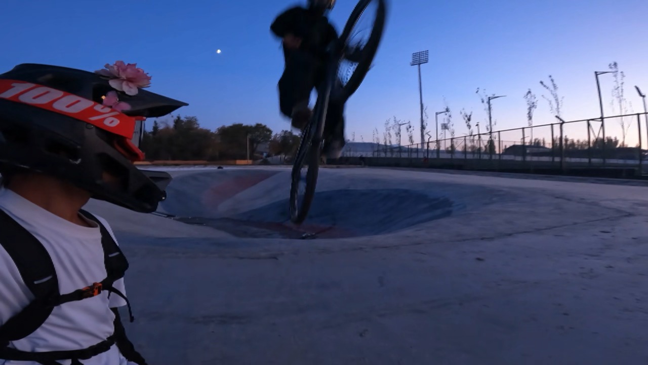 Cyclist’s jump sends bicycle swinging into person's helmet in Bishkek, Kyrgyzstan