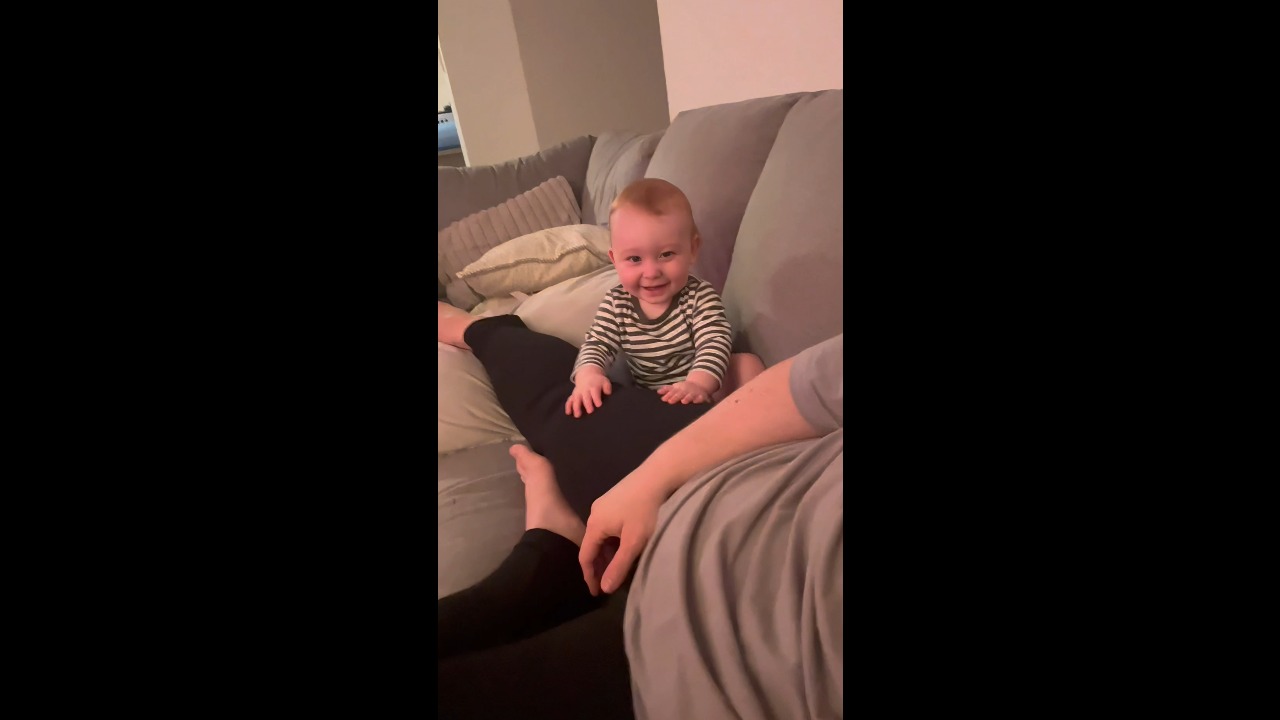 Baby bursts into giggles while playfully tapping his mum in Brisbane, Australia