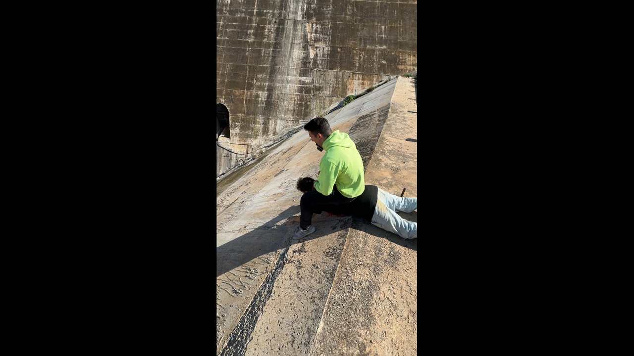 Two men slide down a concrete slope in Almería, Spain