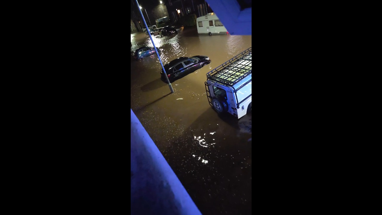 Storm Boelo floods residential streets as a vehicle drifts through deep water in Dumbarton, UK
