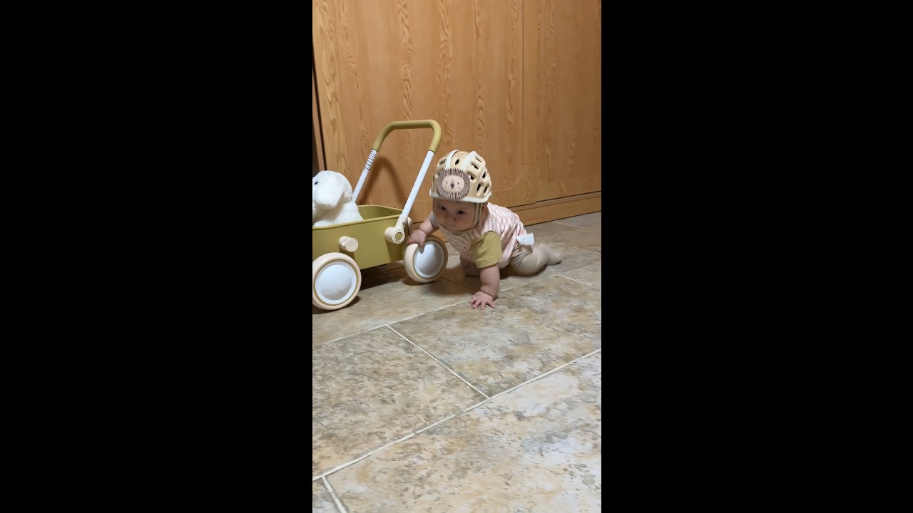 Baby loses balance while holding a toy wagon in Sichuan, China