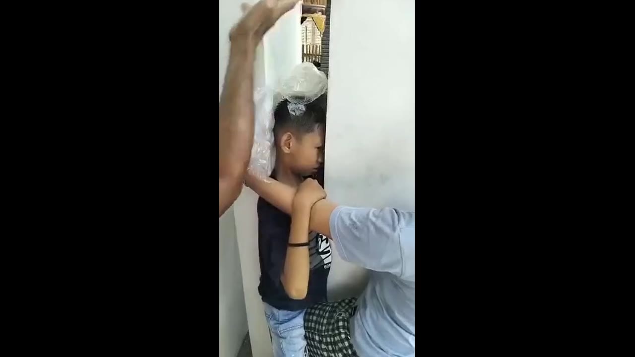 Child's adventure turns Into a sticky situation: rescued from playful peril between pillar and wall