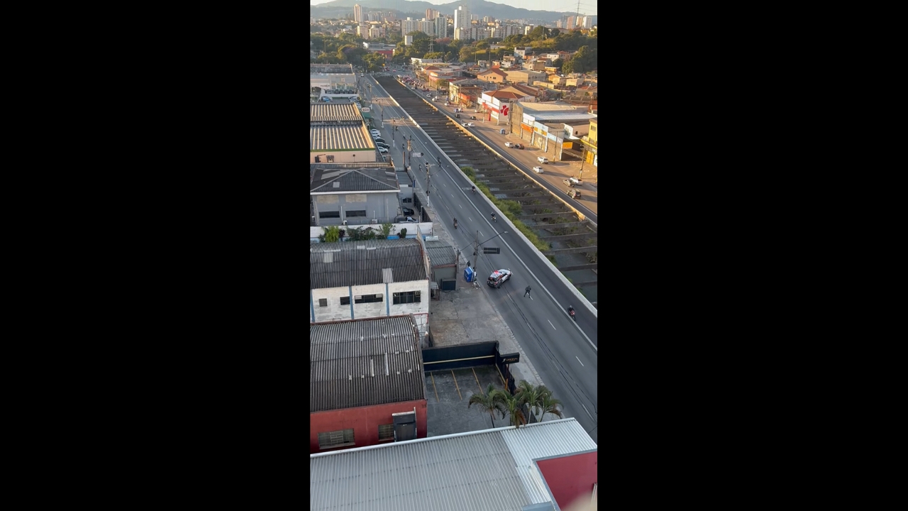 Group of motorcyclists maneuver around police roadblock in São Paulo, Brazil