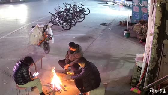 Men startled by fire spark during bonfire in Henan, China