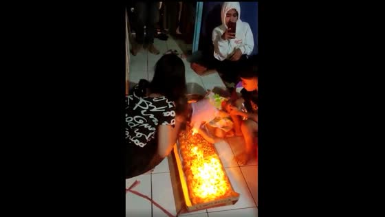 A child blowing out a birthday cake gone wrong