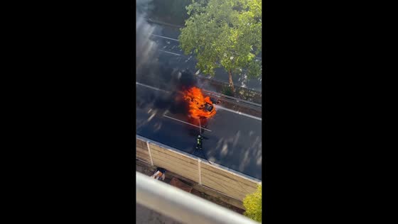 Car catches fire on roadway as firefighters battle flames in Nuremberg, Germany
