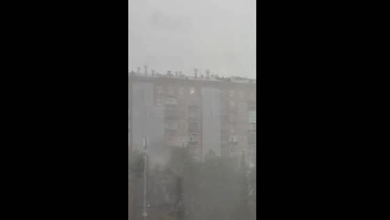 Workers repair Moscow roof amid hurricane winds and heavy downpour