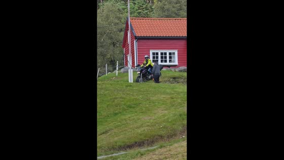 Motorcycle rider loses balance and crashes while descending hill in Stord, Norway