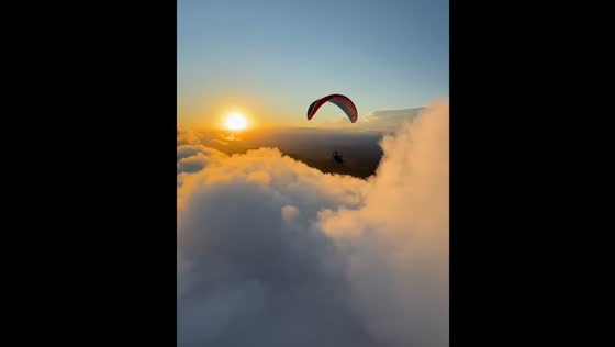 Sunset paramotor flight over the clouds in Rio de Janeiro
