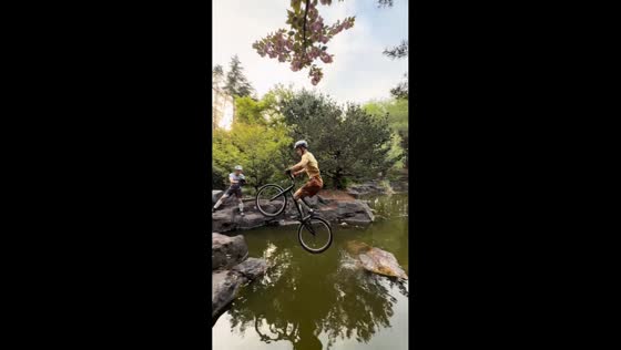 Cyclist shows off parkour skills by jumping across stones in Shanghai, China
