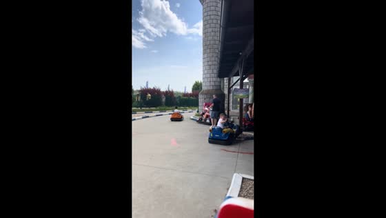 Child lightly crashes go-kart while waving at parent in Neubau, Vienna, Austria