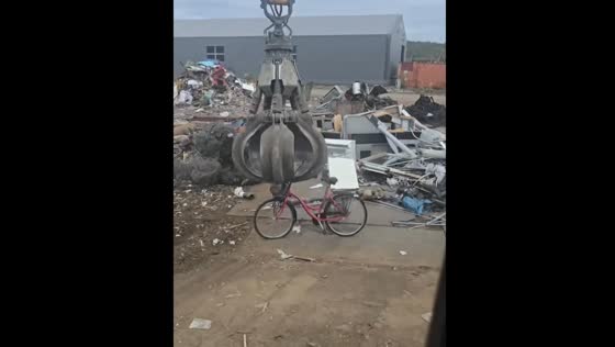 Scooters and bike get playful ride from material handler before disposal