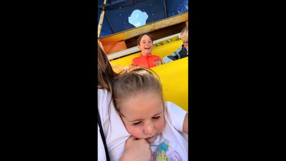 Children react differently while riding pirate ship in Towyn, Wales, UK