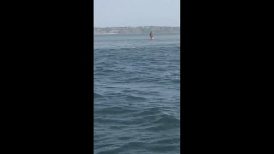 Man seen standing in the middle of the sea in Mussulo, Angola