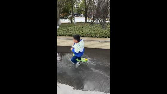 Boy slips and falls while riding scooter in Zhejiang, China