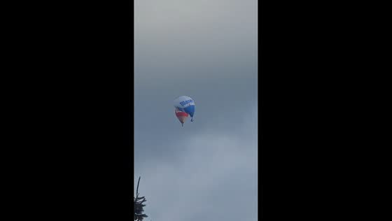 Hot air balloons fly unusually low over Langenthal, Switzerland