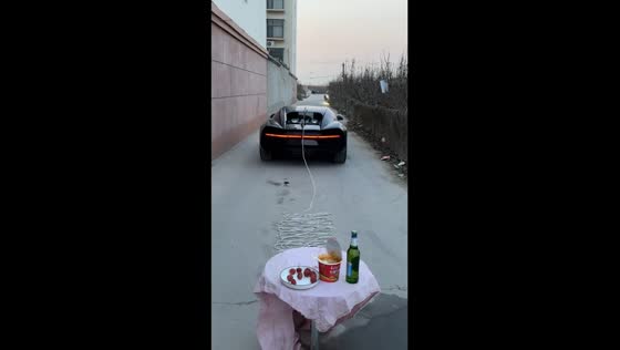 Bugatti replica's tablecloth stunt: food remains intact, bottle shatters