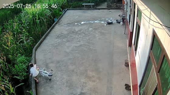 Girl loses balance while cycling and falls off concrete edge in Chongqing, China 