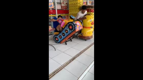 Guy falls off kiddie ride in Malang, Indonesia