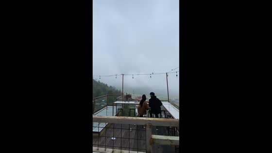Hungry monkey approaches couple during meal in Karanganyar, Central Java, Indonesia
