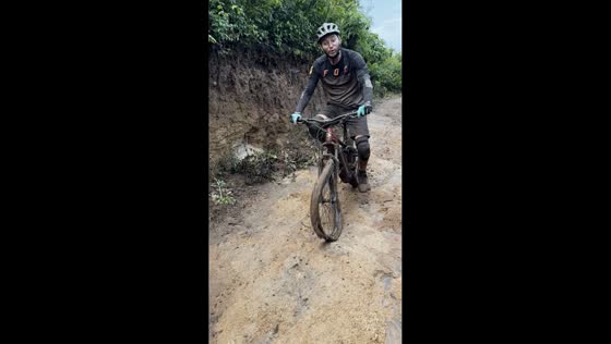 Mountain biker continues downhill with bent front wheel in Guatemala